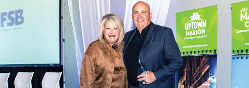 Steve Neighbor accepts the first-ever Marion Chamber of Commerce Business Excellence Award on behalf of Farmers State Bank (FSB).