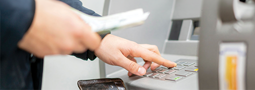 Image of customers using FSB's ATM to deposit funds.