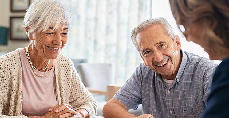 Older couple working with an advisor to determine how much life insurance they need.