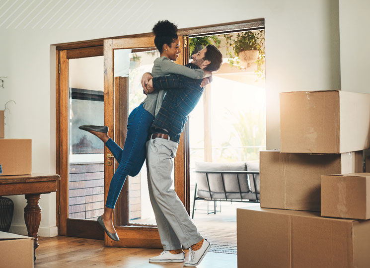 Couple celebrating their move with the help of FSB’s Home Loan options in Eastern Iowa.