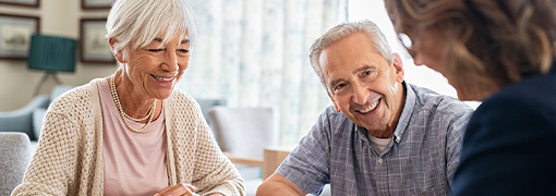 Older couple working with an advisor to determine how much life insurance they need.