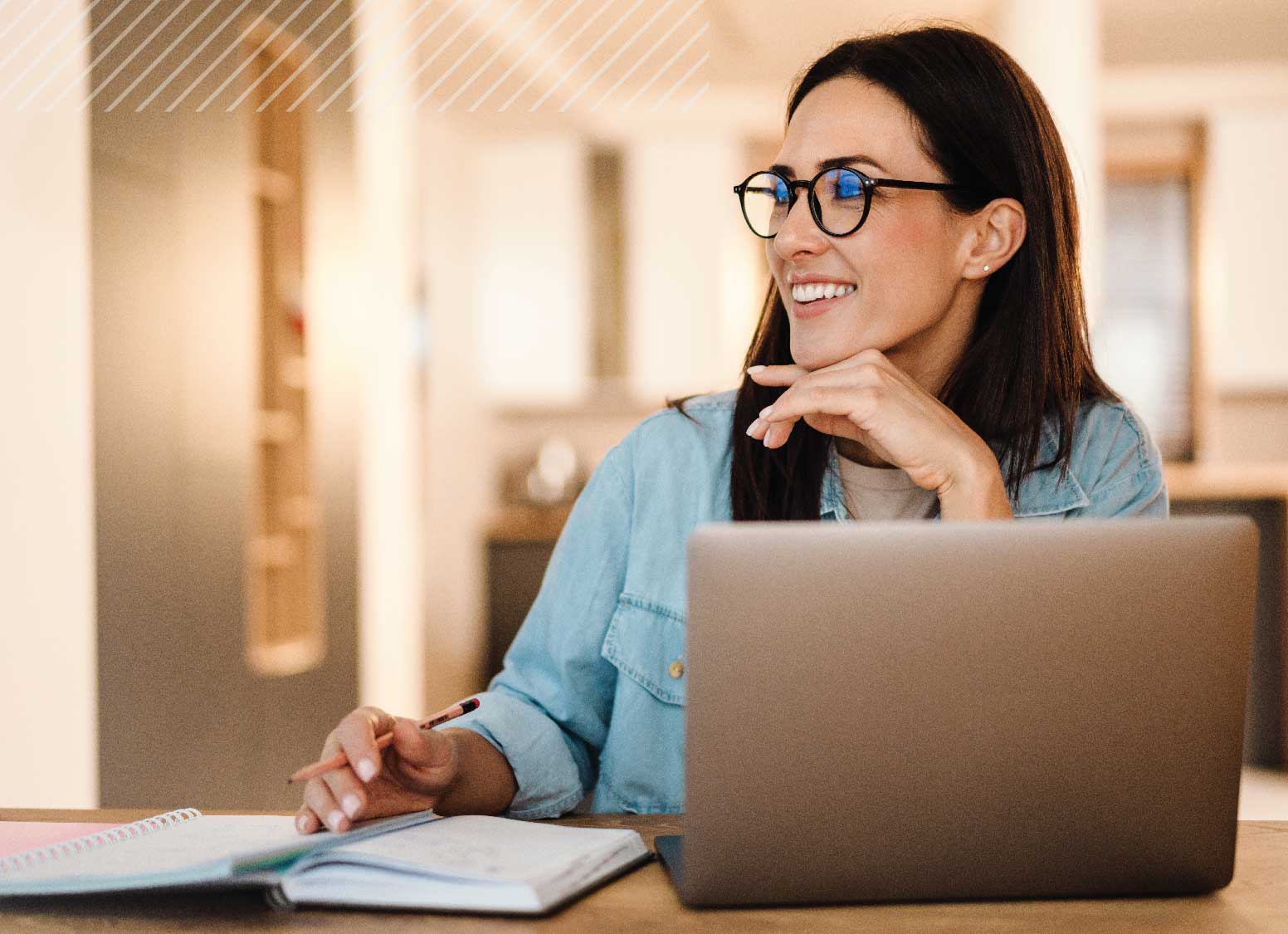 Smiling woman using a laptop to take FSB's financial fitness assessment.