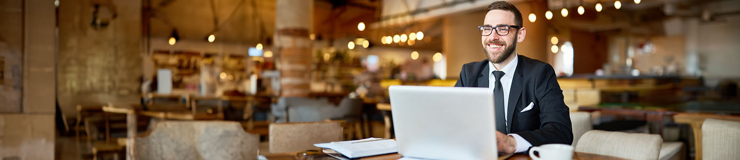 Man sitting in a cafe on his laptop