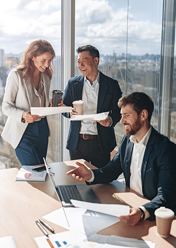 Business team reviewing their bill pay account over coffee in a bright office.