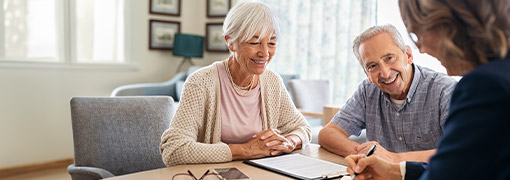 Senior couple meeting with a financial advisor, discussing retirement planning options.