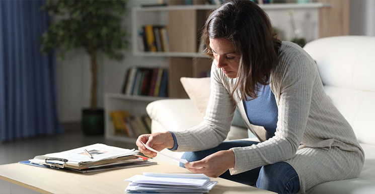 Customer looking at potential fraud mailers sent to her after buying a new home.