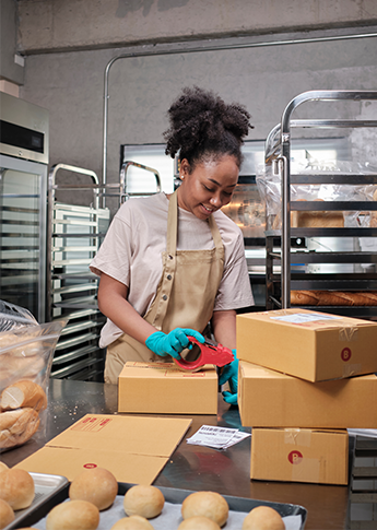 Business person packing products after getting funding from FSB.