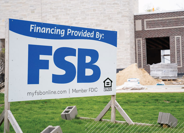 Construction site with signs from FSB, showcasing local business development in Eastern Iowa.