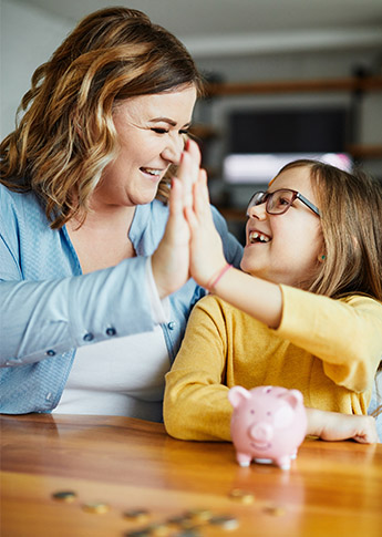 Mother with daughter celebrating saving money in the FSBee Club Saving Account.