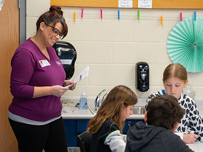 FSB employee teaching children to save for their annual event.