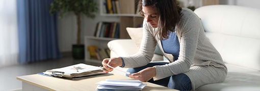 Customer looking at potential fraud mailers sent to her after buying a new home.