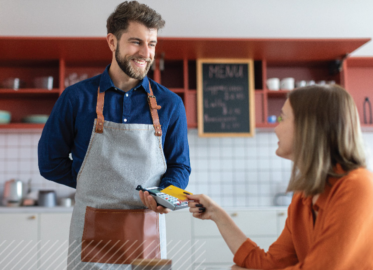 Small business owner in Eastern Iowa managing cash flow with a customer payment transaction.