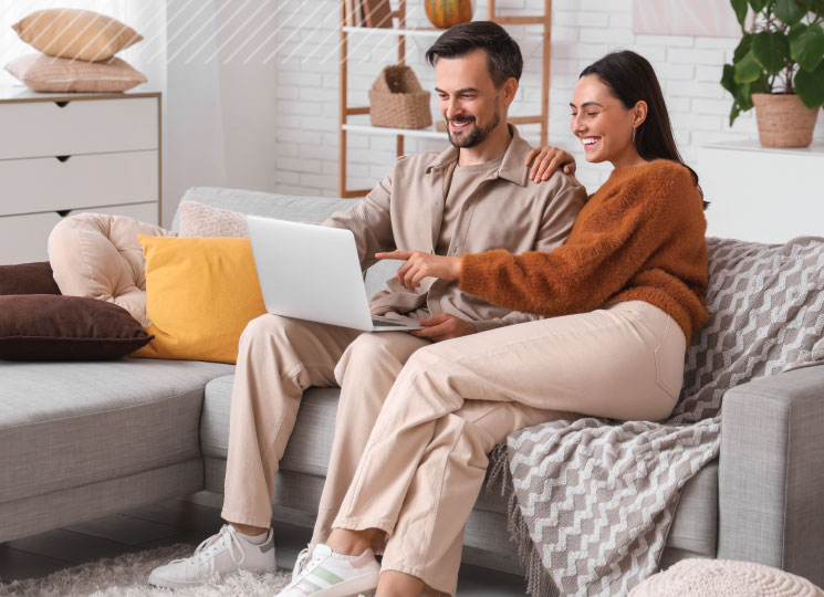 Couple reviewing home loan options in Eastern Iowa on laptop