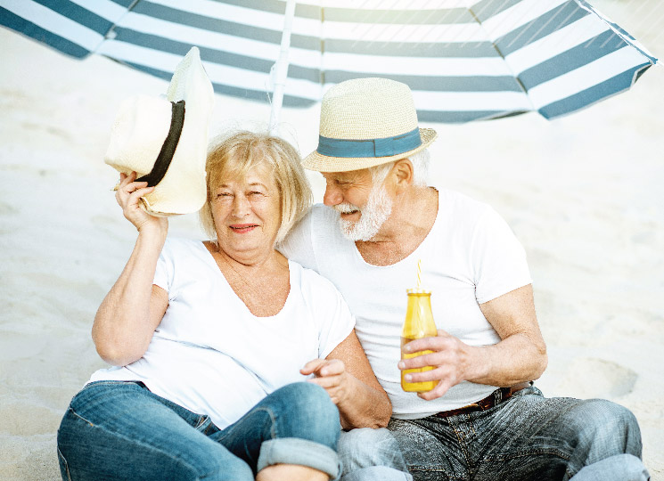 Couple sitting on the beach enjoying retirement after planning with FSB in Marion, IA