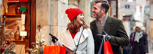 Couple shopping after making a holiday budget using tips from FSB.