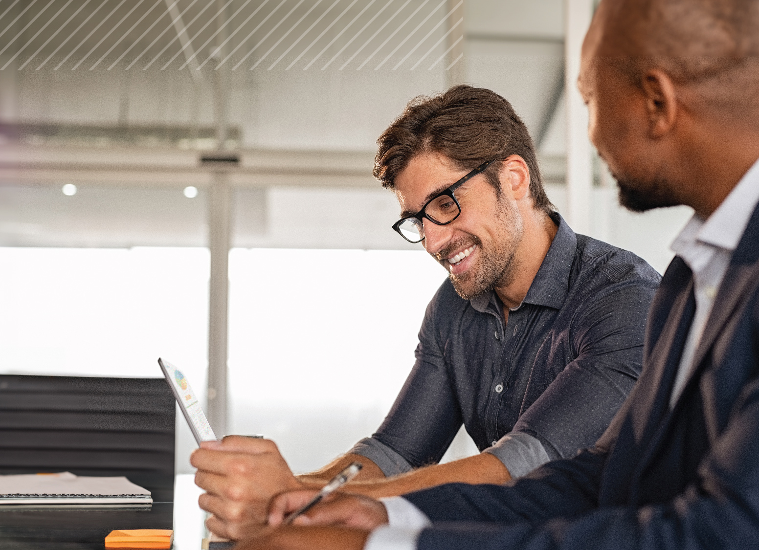 Two professionals discussing documents at a desk during a trust and estate planning seminar.