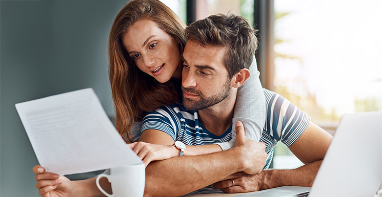 Couple looking at different options for consolidation their debt into one monthly payment.